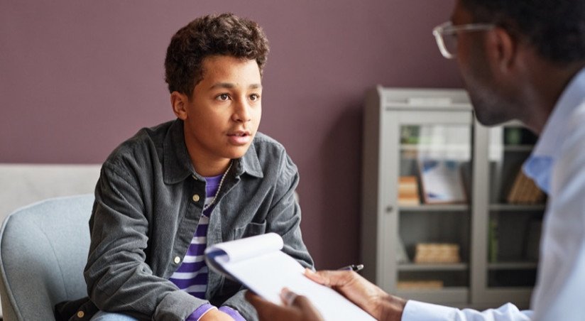 young boy with mental health worker