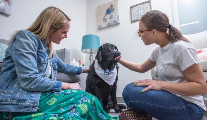 Hopeway counselor with client and therapy dog