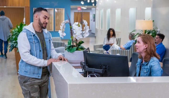 Hopeway patient talking with woman at front desk